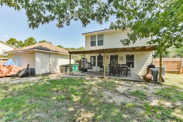 rear view of house with a patio area and a yard