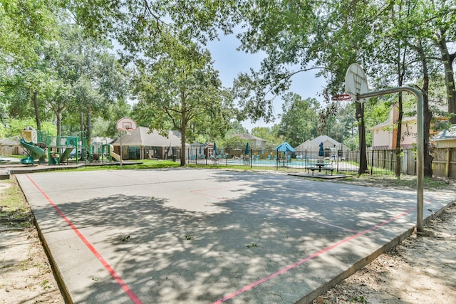 view of community featuring a playground and basketball hoop