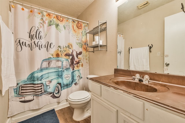 bathroom with vanity, a textured ceiling, toilet, and hardwood / wood-style flooring