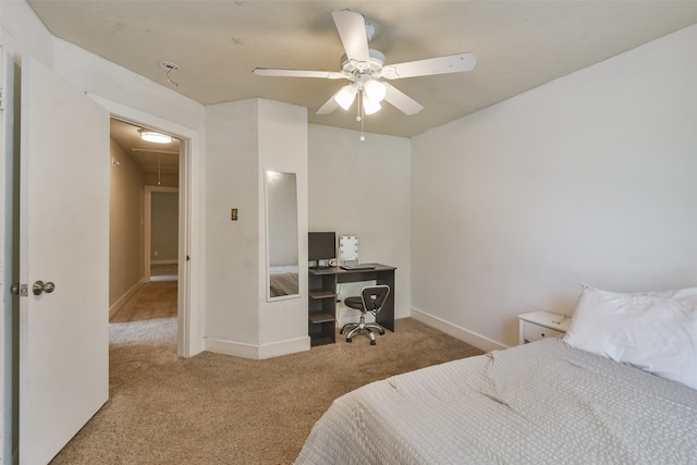 carpeted bedroom with a spacious closet, ceiling fan, and a closet