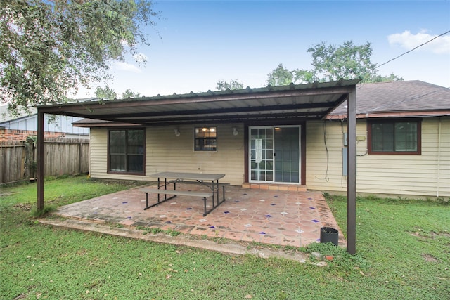 rear view of house with a yard and a patio