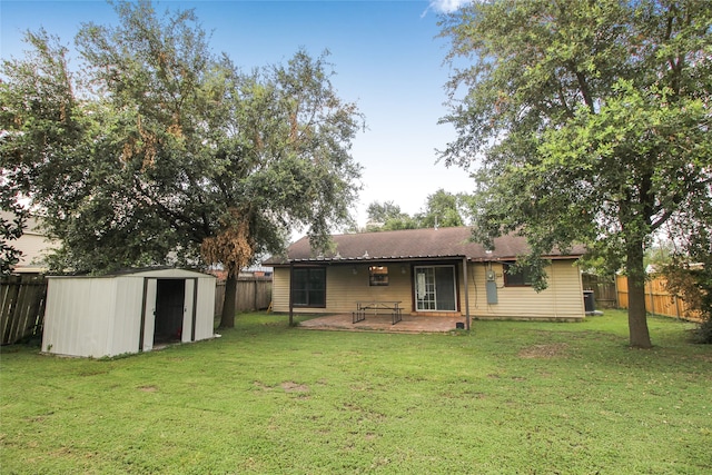 exterior space with a storage unit, a patio area, and a lawn