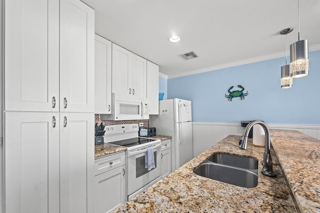 kitchen with decorative light fixtures, white cabinetry, sink, light stone counters, and white appliances