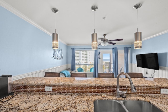 kitchen featuring sink, crown molding, hanging light fixtures, and ceiling fan