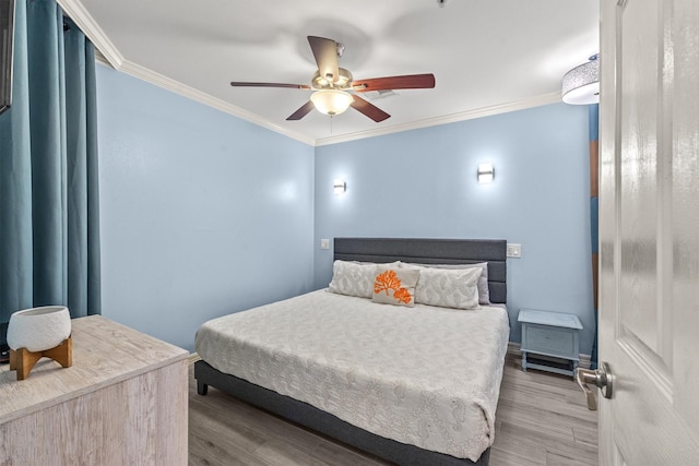 bedroom featuring crown molding, ceiling fan, and hardwood / wood-style flooring