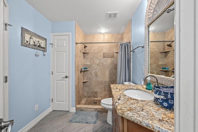 bathroom featuring vanity, wood-type flooring, curtained shower, and toilet