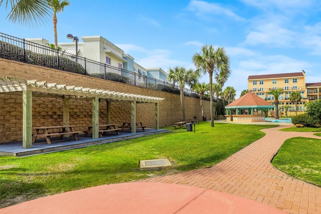 view of home's community featuring a gazebo, a pergola, and a lawn