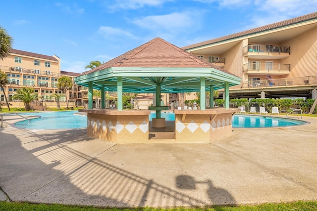 view of pool with a gazebo, an outdoor bar, and a patio area