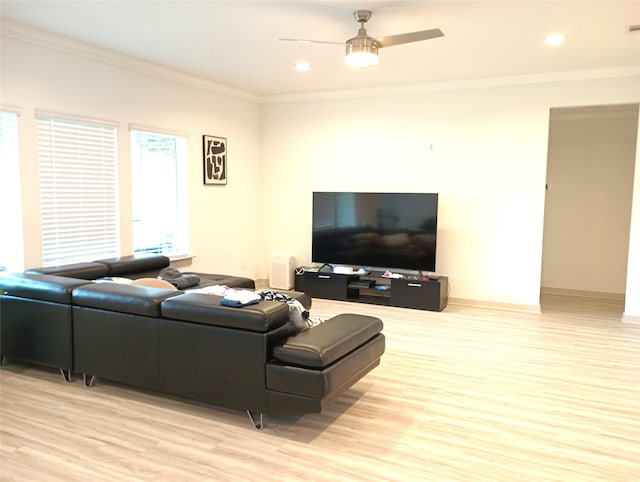 living room featuring ceiling fan, ornamental molding, and light hardwood / wood-style floors