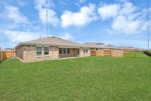 rear view of house with a yard