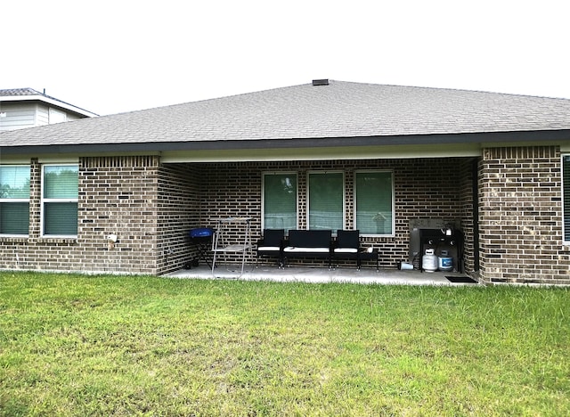 rear view of house featuring a lawn and a patio