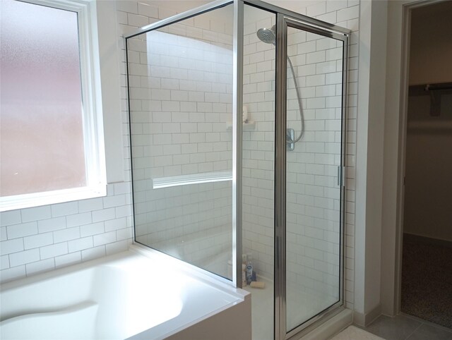 3335 Balboa Grove Ln, Missouri City, TX 77459 - full bath featuring a walk in closet, tile patterned floors, a bath, and a shower stall