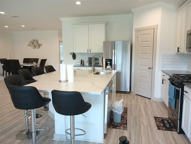 3335 Balboa Grove Ln, Missouri City, TX 77459 - kitchen with a kitchen breakfast bar, light wood-style flooring, light stone counters, stainless steel appliances, and backsplash