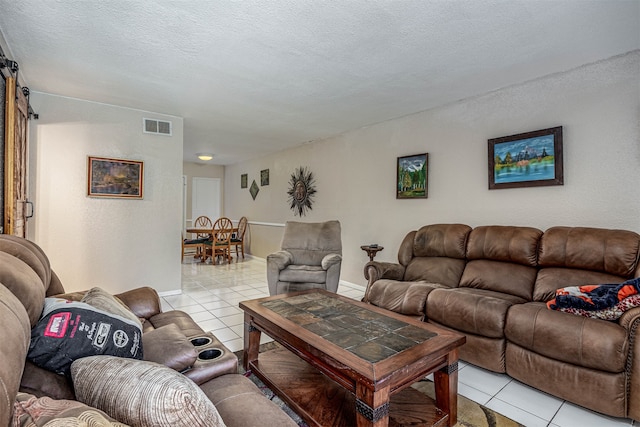 living room featuring light tile patterned flooring and a textured ceiling