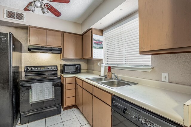 kitchen featuring black appliances, sink, light tile patterned floors, and ceiling fan