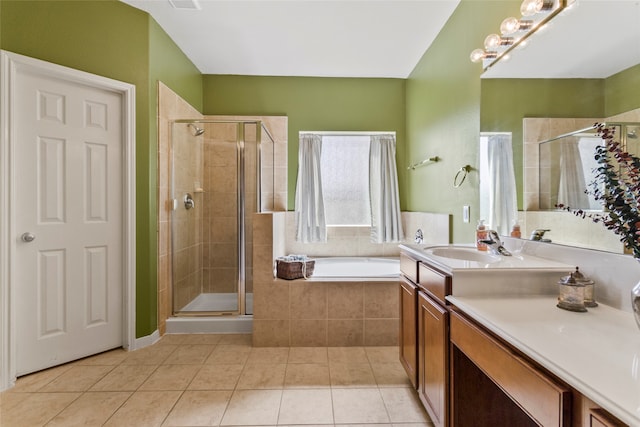 bathroom featuring tile patterned floors, vanity, and shower with separate bathtub