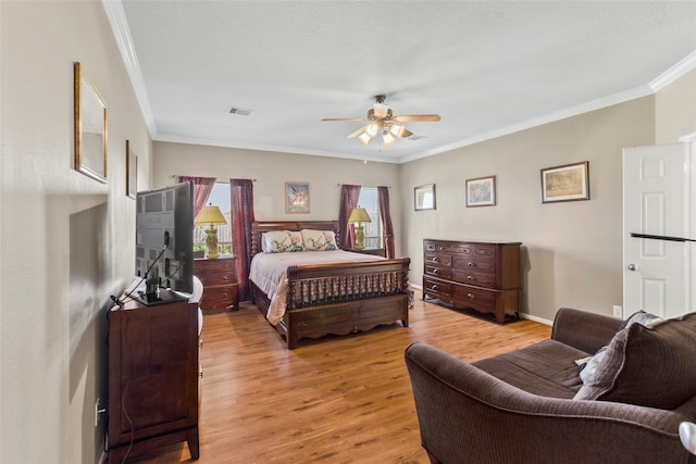 bedroom featuring ceiling fan, crown molding, and light hardwood / wood-style flooring