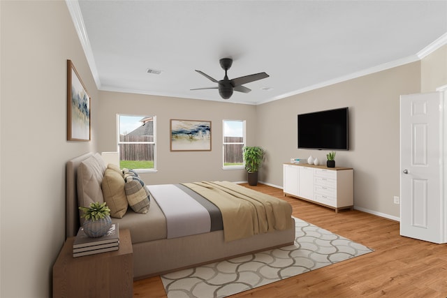 bedroom with ceiling fan, light wood-type flooring, and ornamental molding