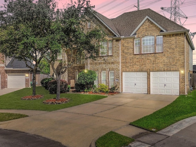 view of front facade with a yard and a garage