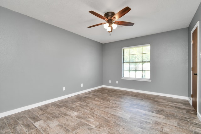 spare room featuring hardwood / wood-style floors and ceiling fan