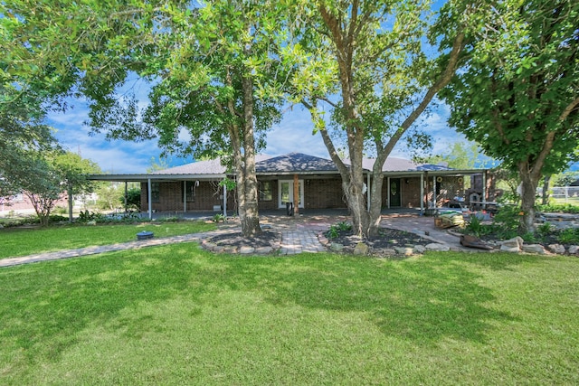 rear view of property featuring a yard