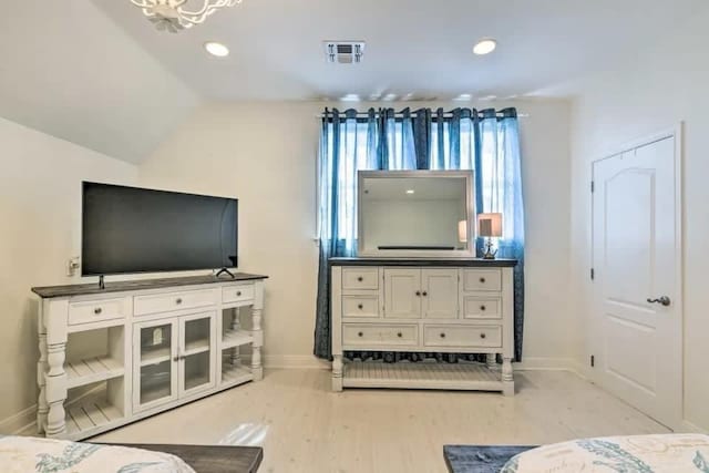 bedroom featuring baseboards, visible vents, lofted ceiling, light wood-style floors, and recessed lighting