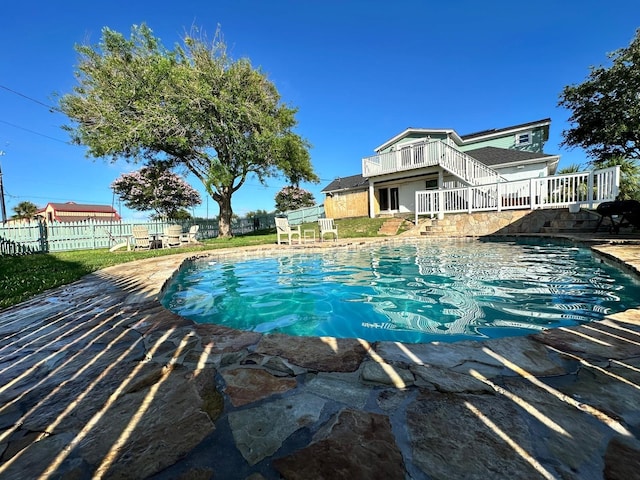 view of swimming pool with a fenced in pool, fence, and a deck