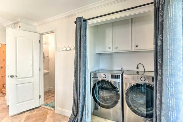 laundry room with washing machine and dryer, ornamental molding, baseboards, and light tile patterned flooring