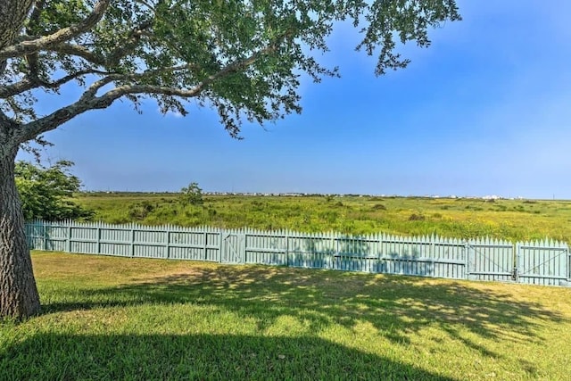 view of yard with a water view and fence