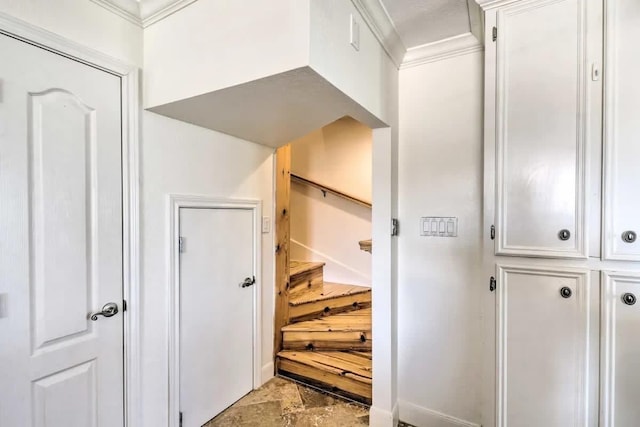 corridor with stone finish flooring, stairway, and crown molding