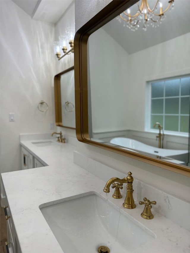 bathroom with vanity and a chandelier