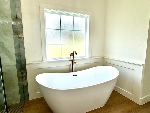 bathroom with shower with separate bathtub and hardwood / wood-style floors