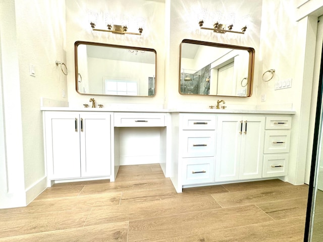 bathroom featuring vanity and a shower