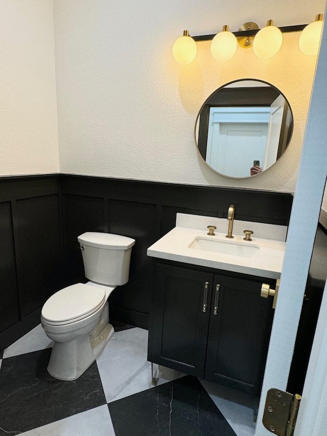 bathroom featuring vanity and toilet