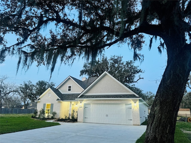 view of front of house with a garage and a front yard