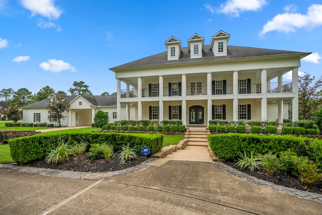 view of front of property featuring a balcony and a garage