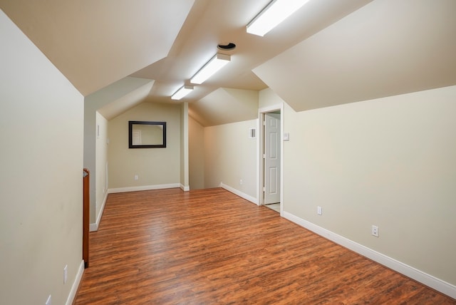 bonus room featuring vaulted ceiling and hardwood / wood-style floors