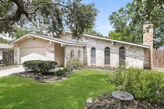 ranch-style house with a garage and a front yard