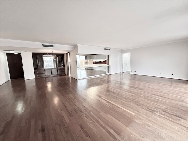 unfurnished living room with dark wood-type flooring