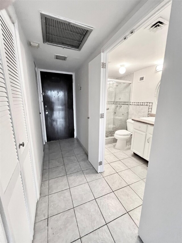 corridor with light tile patterned floors