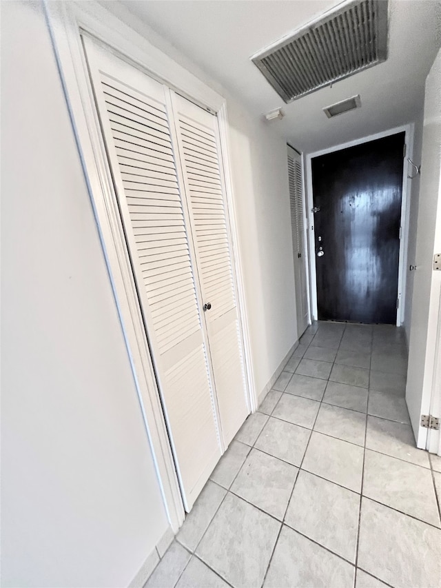 corridor featuring light tile patterned floors