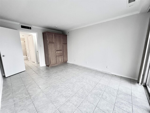 tiled spare room with ornamental molding