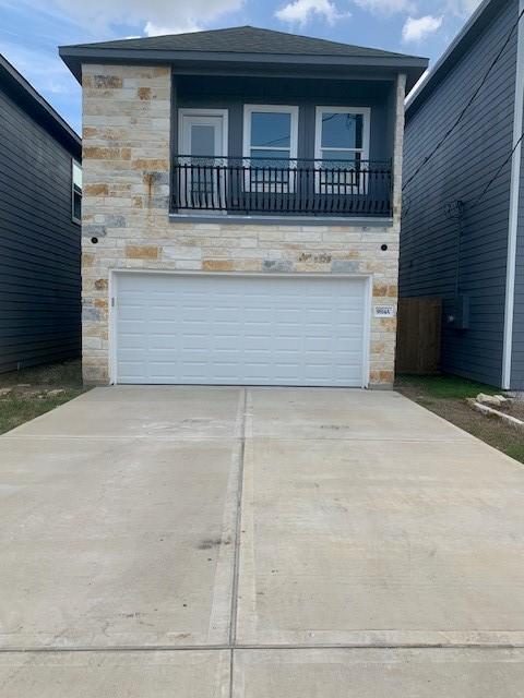 view of front facade with a balcony and a garage