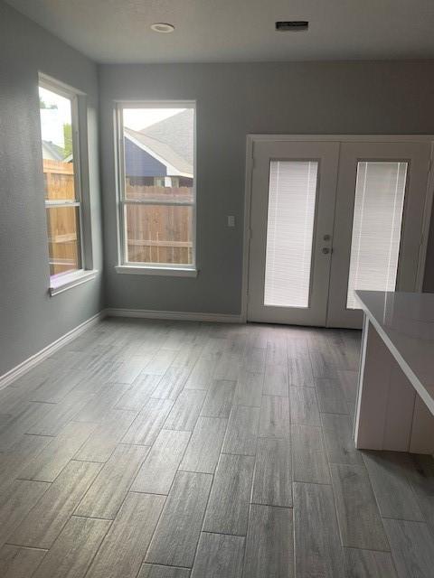 unfurnished dining area featuring french doors