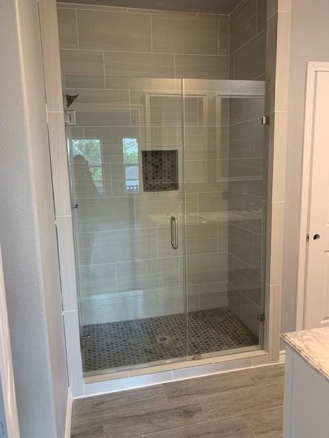 bathroom featuring vanity and a shower with shower door