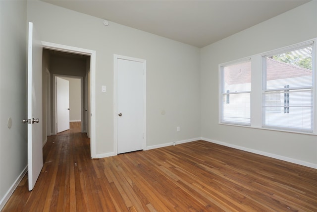 unfurnished bedroom with hardwood / wood-style floors