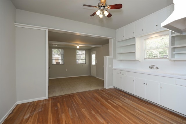 kitchen featuring a healthy amount of sunlight, white cabinetry, ceiling fan, and tile patterned floors