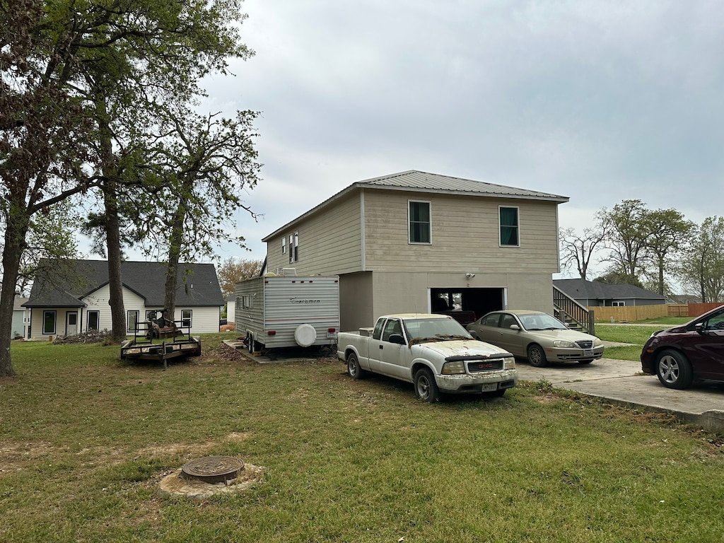 exterior space with a garage and a yard