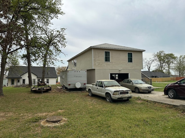 exterior space with a garage and a yard