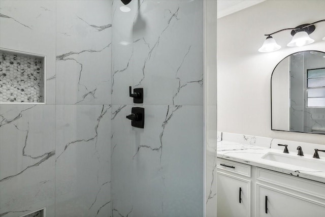 bathroom with vanity and a marble finish shower